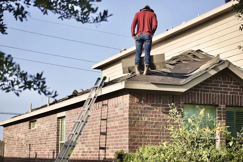 Professional roofer working on a residential roof in Tecumseh Estates